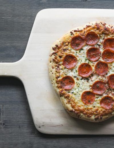 pepperoni pizza on wood board