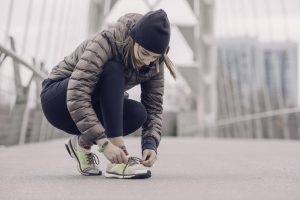 woman athlete tying shoes